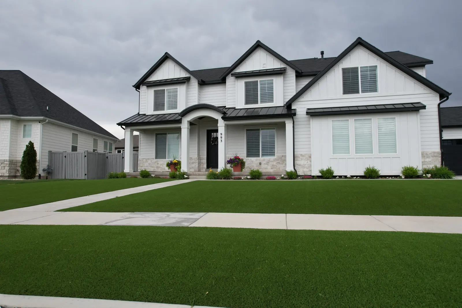 Lush 80 artificial turf front lawn at a modern two-story home, installed by The Turf Yard