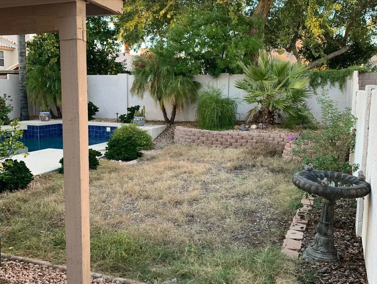 Patchy backyard lawn before artificial turf installation by The Turf Yard